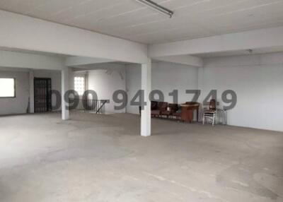 Spacious unfurnished interior of a commercial building with white walls and open floor plan