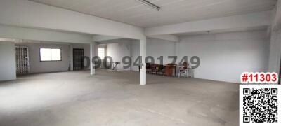 Spacious unfurnished interior of a commercial building with white walls and open floor plan