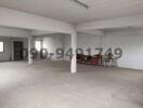 Spacious unfurnished interior of a commercial building with white walls and open floor plan