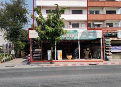 Multi-story residential building facade with ground floor shops