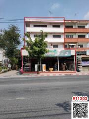 Multi-story residential building facade with ground floor shops