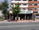 Multi-story residential building facade with ground floor shops