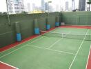 Residential building tennis court with city skyline in the background