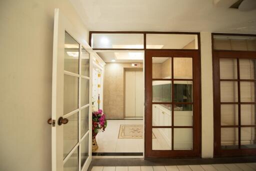Spacious Entryway with Glass Doors and Tiled Flooring