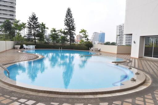 Outdoor swimming pool with cityscape background