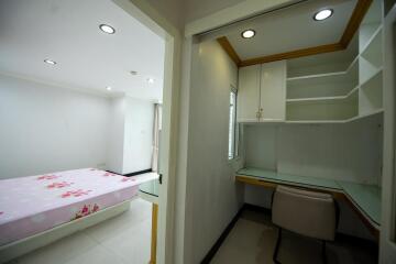 Bright bedroom with study area and ample storage