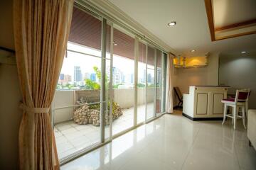 Spacious living room with large windows and balcony access