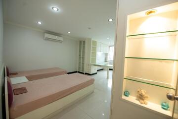 Modern bedroom with integrated shelving and ensuite bathroom