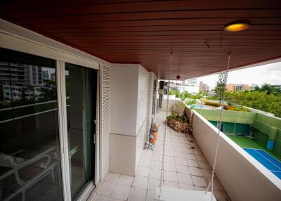 Spacious balcony with wooden ceiling and urban view