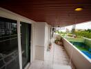 Spacious balcony with wooden ceiling and urban view