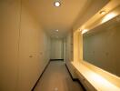 Brightly lit hallway with built-in storage and seating area