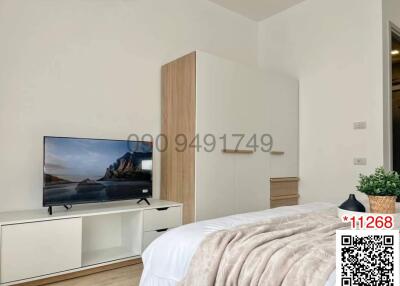 Modern bedroom with large bed and wall-mounted television