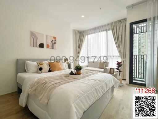 Modern bedroom with comfortable bedding and ample natural light