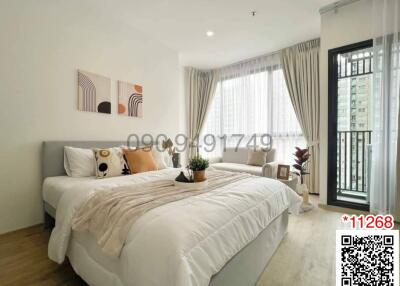 Modern bedroom with comfortable bedding and ample natural light