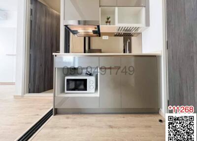 Modern kitchen with built-in appliances and wooden floors