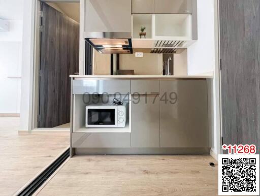 Modern kitchen with built-in appliances and wooden floors