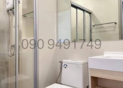Modern bathroom with shower cubicle, toilet, and sink