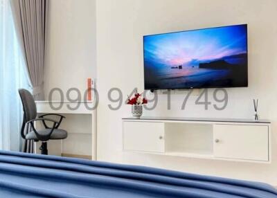 Modern bedroom with mounted TV and air conditioning unit