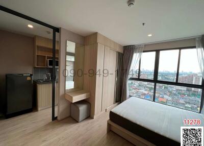 Modern bedroom with kitchenette and city view