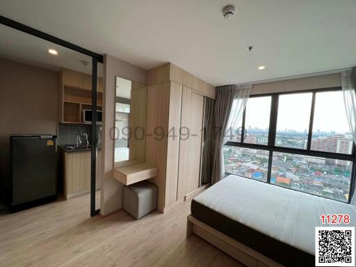 Modern bedroom with kitchenette and city view