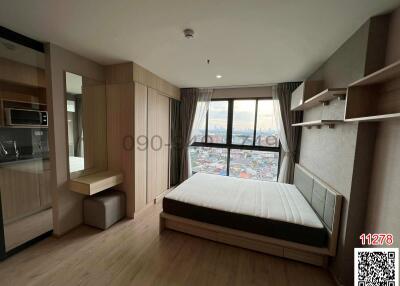 Spacious bedroom with modern design, city view, and built-in wardrobes