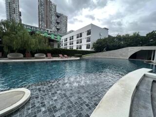 Residential complex with a swimming pool and lounge chairs