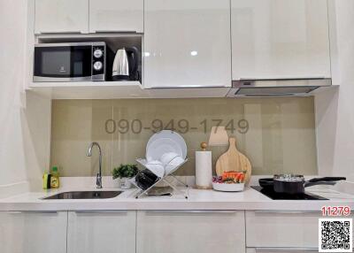 Modern kitchen with white cabinets and stainless steel appliances