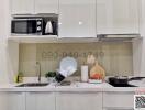 Modern kitchen with white cabinets and stainless steel appliances