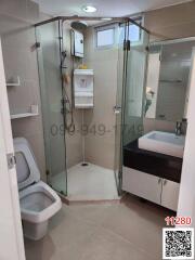 Modern bathroom with glass shower enclosure and white fixtures