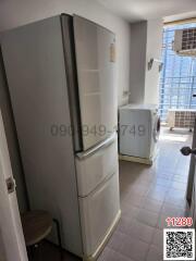 Compact kitchen space with a refrigerator and washing machine