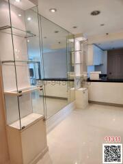 Modern kitchen interior with glass shelving and white cabinetry