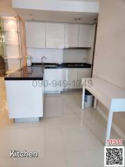 Modern kitchen interior with white cabinets and ceramic tile flooring