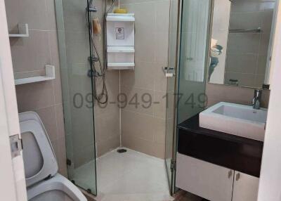 Modern bathroom with glass shower enclosure and vanity