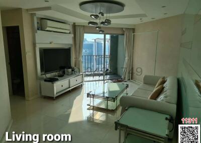 Spacious and well-lit living room with balcony access