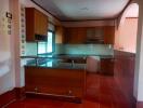 Spacious kitchen with wooden cabinetry and tile flooring