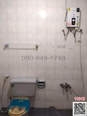 Compact bathroom with wall-mounted shower and toilet