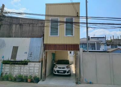 Two-story residential building with car parked in front