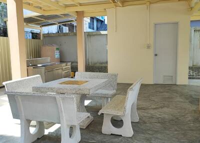 Spacious patio area with a stone table and seating
