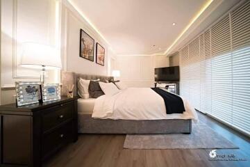 Modern bedroom with a large bed, nightstands, and contemporary decor