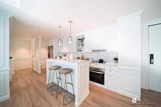 Modern white kitchen with center island and stainless steel appliances