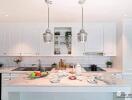 Modern kitchen with white cabinetry and marble countertops