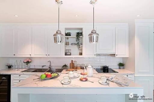 Modern kitchen with white cabinetry and marble countertops