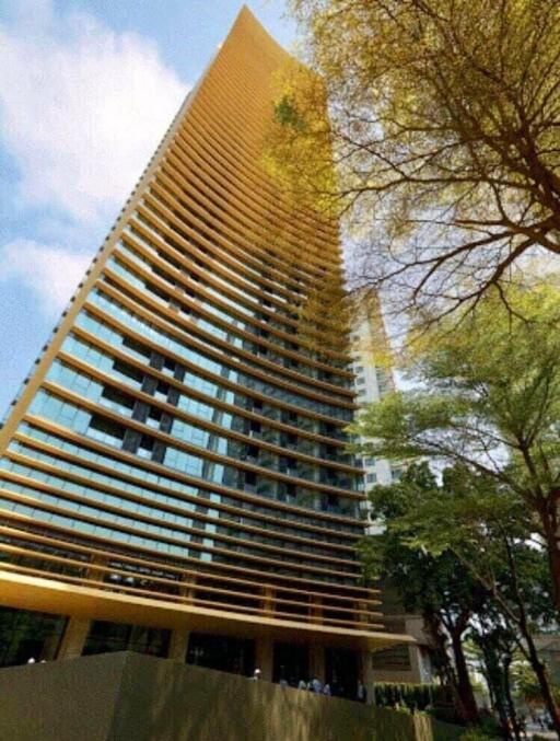 Modern high-rise residential building with lush green trees