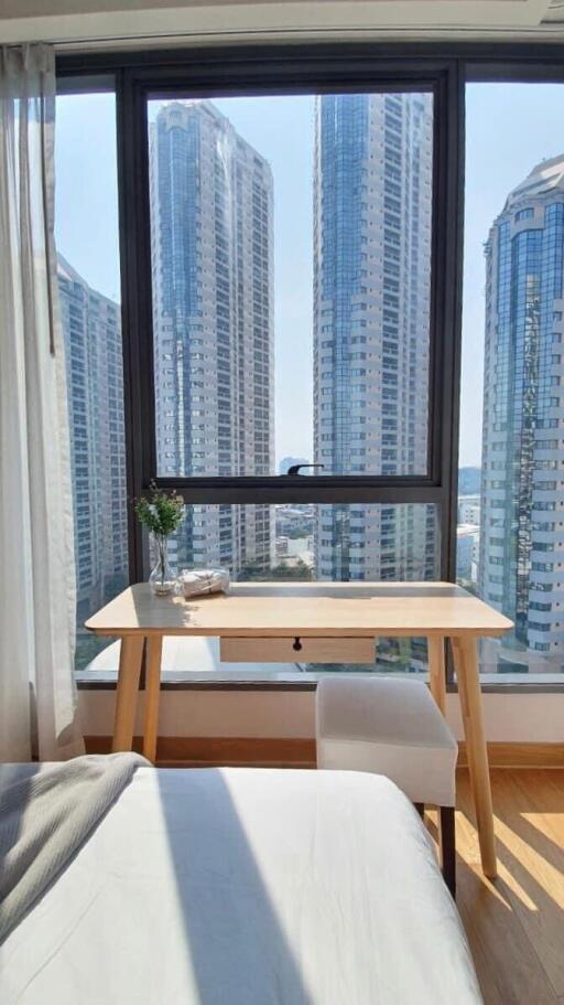 Bright bedroom with a great city view through large window