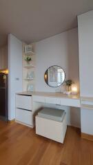 Cozy bedroom with modern vanity, ample lighting and hardwood floor