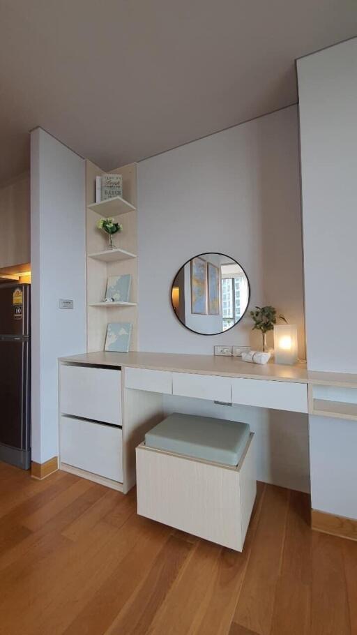 Cozy bedroom with modern vanity, ample lighting and hardwood floor