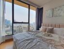 Modern bedroom with large windows and city view