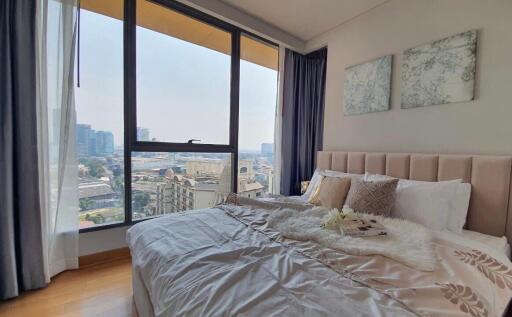 Modern bedroom with large windows and city view