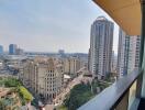 City view from high-rise apartment balcony showcasing surrounding buildings and skyline