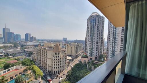 City view from high-rise apartment balcony showcasing surrounding buildings and skyline